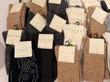 many pairs of socks with tags on them sitting on a table