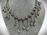 silver plated necklace with dangling drops of diamonds on a mannequin