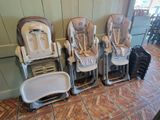 three baby high chairs in a row on the floor