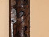 a wooden sculpture on the wall of a room