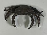 a crab that is sitting on a white surface