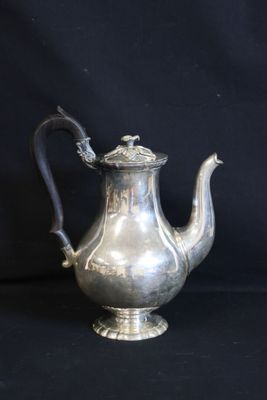 an antique silver tea pot with a handle on a black background