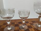 three wine glasses sitting on a table next to each other