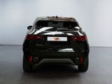 the rear end of a black car in a white room