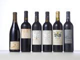 several bottles of wine are lined up on a table
