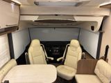 an image of the interior of a camper with a table and chairs