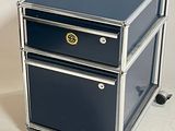 two drawers that are on wheels on a white surface