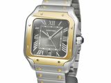 the watch is silver and gold with roman numerals on the dial