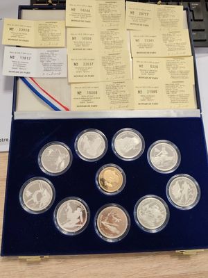 a lot of coins in a box on a table