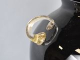 a black vase with a gold ring on it