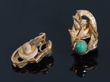 pair of gold earrings with turquoise and pearl accents on a black surface
