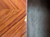 a close up of a wooden door with a black background