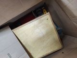 a cardboard box with a wooden cabinet inside of it