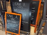 a blackboard sign sitting next to a chalk board sign