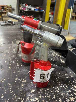 two air tools on a table in a workshop