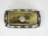a picture of a yellow and black cell phone on a white surface
