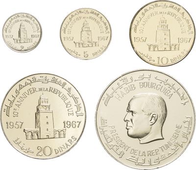 four different types of coins are shown on a white surface
