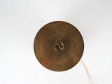 a metal object that is hanging on a white wall