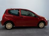 a picture of a small red car parked in a room