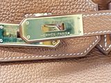 a close up of a purse with a metal handle