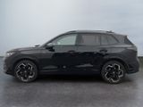 the black suv is parked in a parking lot on a cloudy day