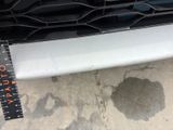 a measuring tape on the front bumper of a car