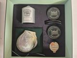 a box containing a bottle of tea, a coin, and other items