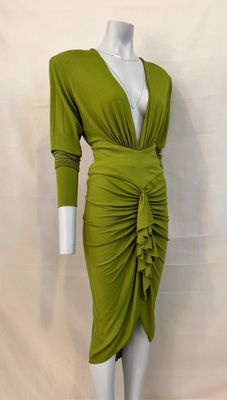 the mannequin is wearing a green dress with a ruched skirt