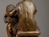 bronze statue of a woman and child sitting on a bench