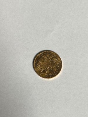 une pièce d'or posée sur une surface blanche