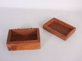 two small wooden boxes are sitting on a white surface