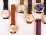 a lot of watches that are sitting on a table