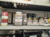 de nombreux bocaux remplis de nourriture posés sur une étagère dans une cuisine