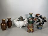 many vases that are sitting next to each other on a table