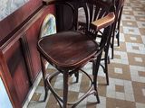 a row of bar stools in a restaurant with a checkered floor