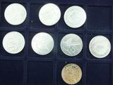 a lot of different coins in a blue box