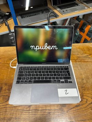 a laptop computer sitting on top of a wooden table