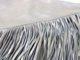 silver leather purse with fringes on a white background