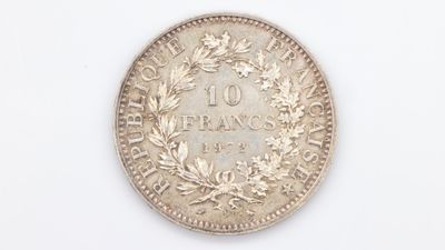 a close up of a coin on a white surface