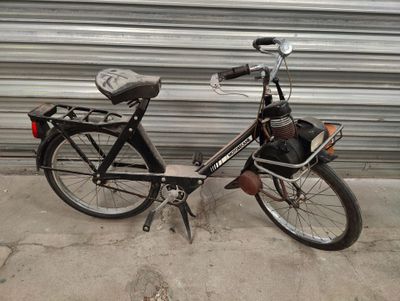 a black bicycle parked next to a garage door