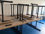 a row of desks in a room with a blue floor