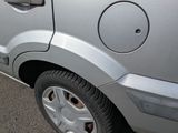 a car that has been painted silver and is parked on the side of the road