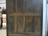 a large wooden cabinet in the middle of a room