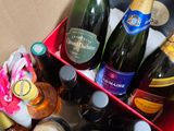 many bottles of wine in a red box on a table