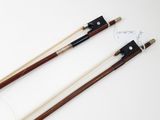 a pair of chinese style chopsticks with wooden handles and a black and white handle