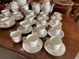 a lot of cups and saucers on the table