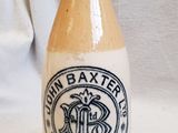 a small bottle with a logo on it sitting on a table