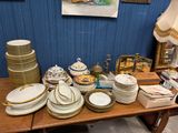 une table sur laquelle se trouvent beaucoup d'assiettes et de bols