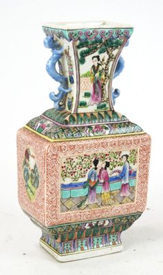 a vase with a painting on it sitting on a table
