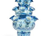 a blue and white vase that has a bunch of blue flowers on it